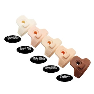May include: Six plastic doll heads in different skin tones, from lightest to darkest: Super White, Peach Pink, Milky White, Normal White, Coffee. Each head has a small hole in the center.