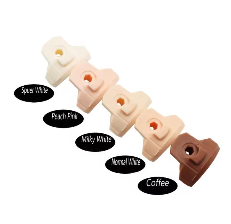 May include: Six plastic doll heads in different skin tones, from lightest to darkest: Super White, Peach Pink, Milky White, Normal White, Coffee. Each head has a small hole in the center.