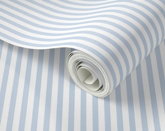 May include: A roll of wallpaper featuring a repeating pattern of vertical stripes in light blue and white. The wallpaper is partially unrolled, revealing the pattern and texture of the material. The stripes are evenly spaced and create a classic, clean design.