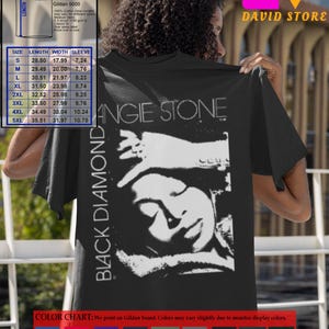 May include: Black t-shirt with a white graphic of a woman's face with the text "Black Diamond" and "Angie Stone" printed on the front. The shirt is a Gildan 5000 unisex tee, available in sizes S-5XL. A size chart is included with measurements in inches.