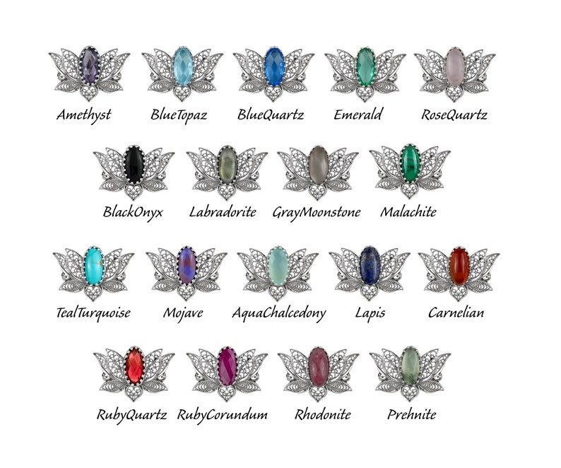 May include: A set of 16 silver filigree brooches with different colored gemstones. The brooches are shaped like a lotus flower with a gemstone in the center. The gemstones are amethyst, blue topaz, blue quartz, emerald, rose quartz, black onyx, labradorite, gray moonstone, malachite, teal turquoise, mojave, aqua chalcedony, lapis, carnelian, ruby quartz, ruby corundum, rhodonite, and prehnite.