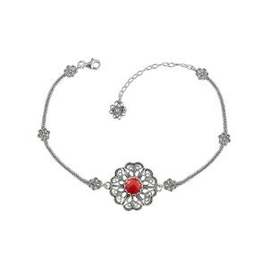 May include: A silver bracelet with a red gemstone in a filigree flower design. The bracelet has a delicate chain and small flower accents.