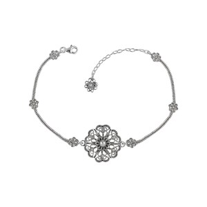 May include: A silver bracelet with a delicate floral design. The bracelet features a large, ornate flower charm in the center and smaller flower charms on the sides. The bracelet is made of a thin chain and has a lobster clasp.