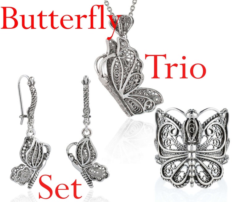 May include: A silver butterfly pendant necklace, a pair of silver butterfly earrings, and a silver butterfly ring. The jewelry set is called "Butterfly Trio Set".