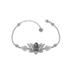 May include: A silver bracelet with a filigree design featuring a purple gemstone in the center. The bracelet is shaped like a lotus flower.