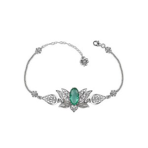 May include: A silver bracelet with a green gemstone set in a filigree lotus flower design.