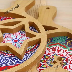 May include: Two wooden serving trays with intricate star-shaped cutouts. The trays are decorated with colorful geometric patterns and the text "Itsy Bitsy Craft studio" is visible on both trays.