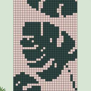 May include: C2C Monstera Leaves throw blanket pattern. A grid pattern with green squares on a light pink background, forming the shape of a Monstera leaf.