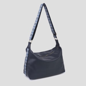 Navy blue shoulder bag with detailed strap