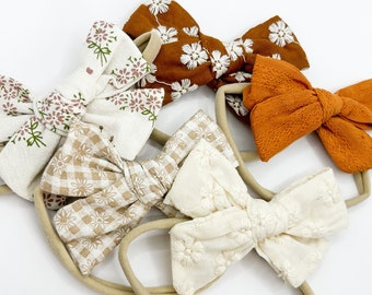 Baby Headband Bow, Neutral fabric bow with soft stretchy nylon band.