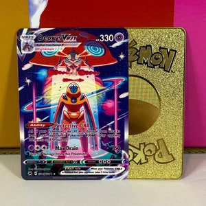 May include: A Deoxys VMAX Pokemon card with a gold foil border. The card features a purple, pink, and blue background with a holographic image of Deoxys VMAX in the center. The card's text reads "Deoxys VMAX", "Evolves from Deoxys V", "Dynamax", "330", "Ability: Protective DNA", "All of your Pokemon take 30 less damage from attacks from your opponent's Pokemon VSTAR (after applying Weakness and Resistance)", "Max Drain: Deal 160 damage from this Pokemon", "VMAX Rule: When your Pokemon VMAX is Knocked Out, your opponent takes 3 Prize cards."