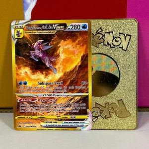 May include: A gold Pokemon trading card featuring Origin Forme Palkia VSTAR with a gold background and the text "Origin Forme Palkia VSTAR" and "280".