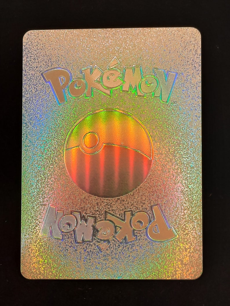 May include: A holographic Pokemon card back with a silver background and a rainbow colored Pokeball logo. The text "Pokemon" is printed in a silver font at the top and bottom of the card.