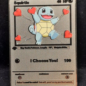 May include: A silver-colored Squirtle Pokémon card with a light blue Squirtle character, yellow shell, and red hearts. The card reads "I Choose You!" and has the text "I don't need to catch 'em all, you're my perfect catch."