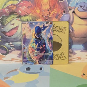 May include: A Sawk Pokémon trading card with a blue and white design, featuring the text "Elbow Strike" and "Rising Chop." A gold-colored Pokémon card is next to it, with a background of various Pokémon characters.