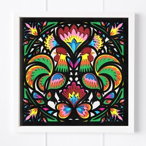 May include: A colorful paper cut art piece featuring two roosters with intricate designs and a butterfly in the center. The roosters are facing each other and have green, red, yellow, and blue feathers. The butterfly has pink, blue, and yellow wings.