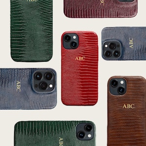 May include: A collection of leather-textured phone cases in various colors, including green, red, blue, and brown. Each case features the monogram "ABC" in a contrasting color. The cases are designed to fit a smartphone with a camera.