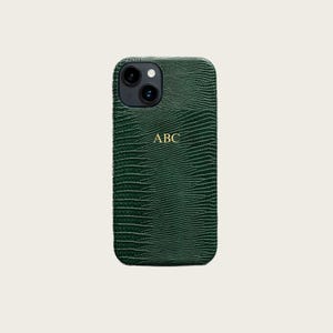 a green, textured case with a gold "ABC" logo on the back.