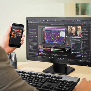 A man is looking at pumpkin emotes on his android phone while watching Twitch.
