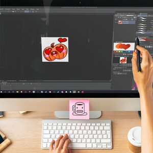 A pumpkin emote is being designed on a screen