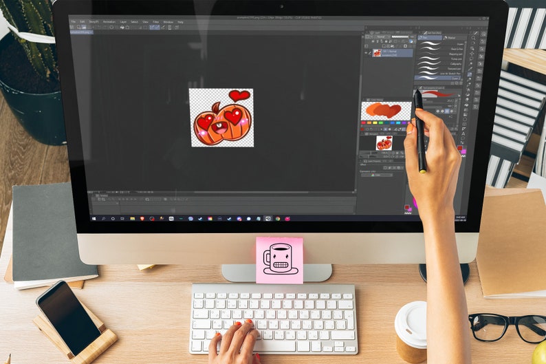 A pumpkin emote is being designed on a screen