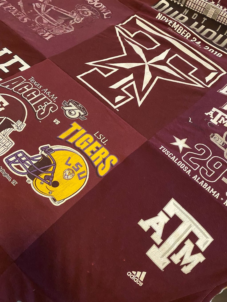 May include: A maroon fabric quilt with various patches featuring college logos and text. The patches include the logos for Texas A&M Aggies, LSU Tigers, Alabama Crimson Tide, and a star with the text "Tuscaloosa, Alabama". The quilt also features the text "Old  House" and "November 24, 2018".