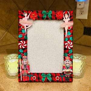 May include: A white ceramic mug with a black handle and the text "But First, Coffee" in a bold, black font. The mug is set against a blurred background, suggesting a cozy setting. The mug appears to be approximately 4 inches tall.