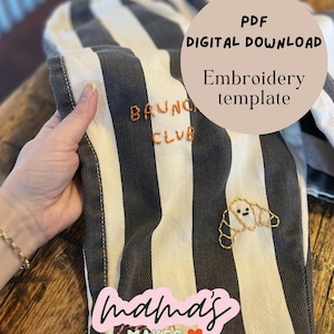 May include: Close-up of striped fabric with embroidered details. The fabric has black and white stripes. Embroidered on the fabric are the words "BRUNCH CLUB" and a croissant. The text "PDF DIGITAL DOWNLOAD Embroidery template" is also visible.