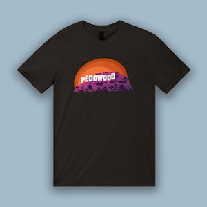 May include: Black t-shirt with a graphic of a mountain range with the word "PEDOWOOD" printed on it in white letters.