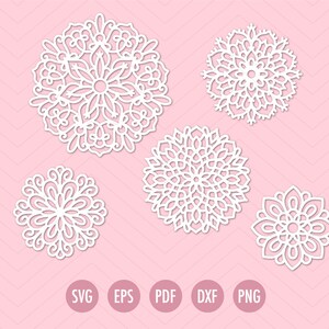 Puede incluir: Cinco diseños de mandala circulares blancos e intrincados sobre un fondo rosa con un patrón de chevrón. Los diseños varían en tamaño y detalle. La parte inferior de la imagen muestra las abreviaturas de los tipos de archivo: SVG, EPS, PDF, DXF y PNG.