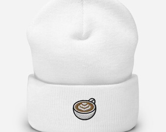 May include: White knit beanie with a brown and white embroidered coffee cup design.