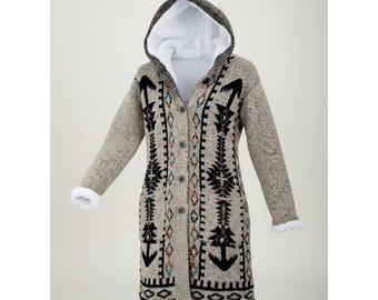 May include: A long, hooded cardigan in a neutral beige color with a white, fluffy interior lining. The sweater features a geometric pattern in black, orange, and blue. The cuffs and hood trim are lined with white faux fur.