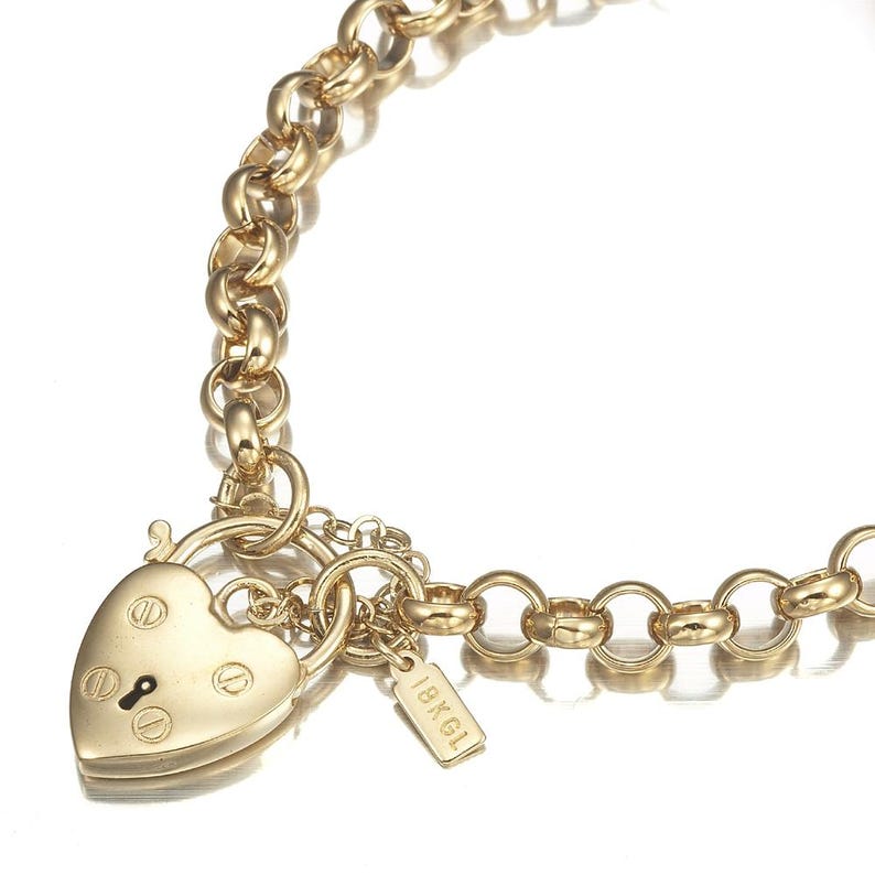May include: A gold chain necklace with a heart-shaped padlock charm and a small tag that says "1BKG1".