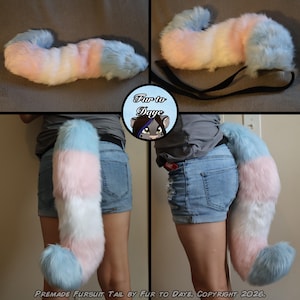 May include: A long, plush faux fur tail featuring horizontal stripes in pastel blue, white, and pink. The tail includes black elastic straps for attachment and is displayed in various positions, including hanging down and curved, with the text Fur to Daye.