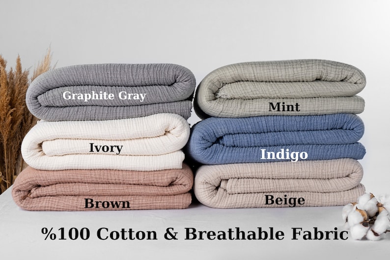 Puede incluir: Cinco muestras de tela de algod&oacute;n dobladas en diferentes colores: gris grafito, marfil, marr&oacute;n, menta, &iacute;ndigo y beige. El texto "100% algod&oacute;n y tejido transpirable" est&aacute; debajo de las muestras.
