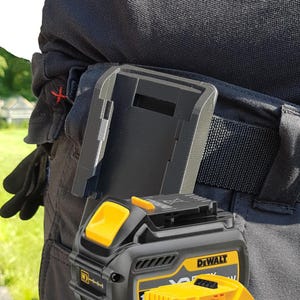 May include: Black and yellow DeWalt 18V XR Li-Ion 5.0 Ah battery pack and holder attached to a black belt. The battery pack has a yellow top and the DeWalt logo. The holder is black and has a clip to attach to a belt.