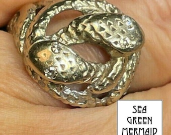 Anillo de oro blanco de 14 k con doble serpiente y nudo de amor con diamantes. Ancho.