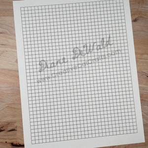 May include: A blank white sheet of paper with a grid pattern. The grid is made up of small squares. The paper is perfect for drawing, sketching, or taking notes.