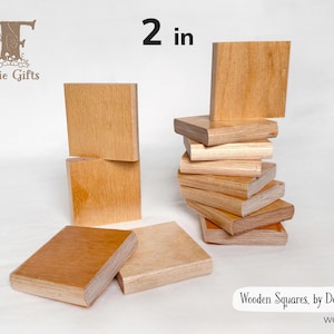 May include: Wooden squares, each measuring 2 inches. Several squares are stacked, while others are scattered. The wood has a light brown color. The text "Wooden Squares, by Dozen" is visible.