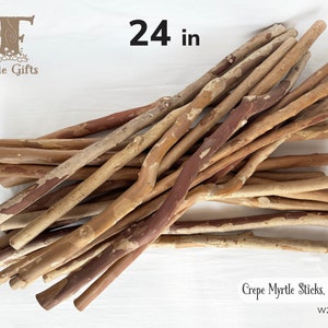 May include: A pile of Crepe Myrtle sticks, each approximately 24 inches long. The sticks have a natural, rustic appearance with varying shades of brown and tan bark. The text "Faerie Gifts" is in the upper left corner.
