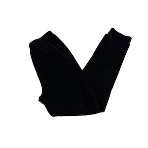 May include: Black velvet pants with an elastic waistband. The pants are folded and displayed on a white background. The fabric has a soft, luxurious appearance.