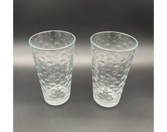 May include: Two clear glass drinking glasses with a textured, bubble-like pattern.