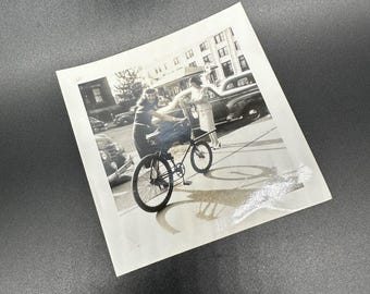 Vintage 1940s Black and White Photo Of Woman Bicycle On City Street Car Retro