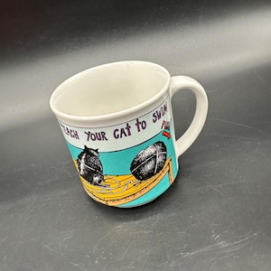 ヴィンテージマグカップ 日本 ユーモア キッチュ 1980年代 ケビン・ポープ 猫に泳ぎを教える方法 セラミックカップ