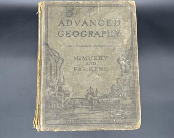 May include: An antique book titled "Advanced Geography" with the text "With Missouri Supplement" and the names "McMurry and Parkins" on the cover. The cover is a faded green color with an illustration of a city and the text "The MacMillan Company".