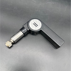 May include: A black and silver tool with a hinged design. The tool has a cylindrical silver component with a textured end, and a black handle with the word "KONE" printed on a circular plate.