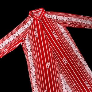 May include: A red and white striped robe with a mandarin collar and long sleeves. The robe features vertical white stripes and decorative white floral patterns along the sleeves and edges. The robe is made of a lightweight fabric.