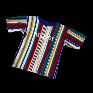 May include: A short-sleeved t-shirt with vertical stripes in red, blue, yellow, green, and white. The shirt has a blue collar and the words "BUGLE BOY USA" in white across the chest.