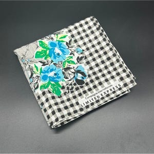 May include: A white and black checkered handkerchief with a floral design and the text "Compagnie Internationale LIMITED EXPRESS".