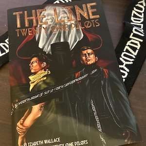 May include: A comic book cover titled "The Line" by Twenty One Pilots. The cover features two men in dark clothing, with a red and white figure in the background. The comic book is a collaboration between Elizabeth Wallace and Twenty One Pilots.